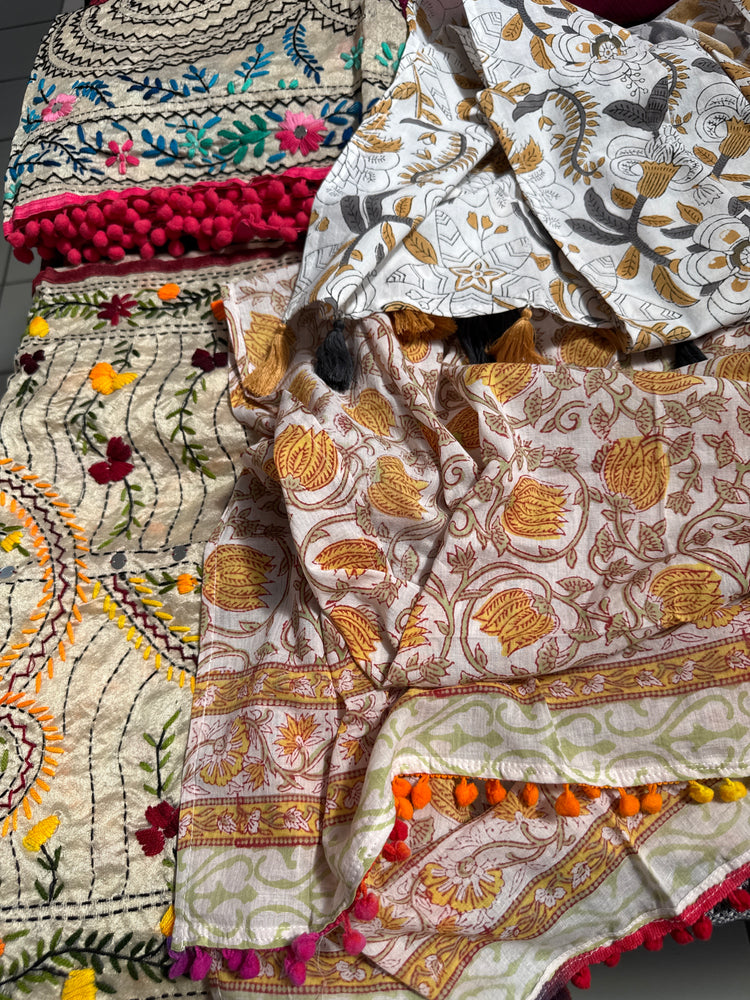 Collection of pure silk and organic cotton stoles with intricate floral and geometric designs in vibrant colors